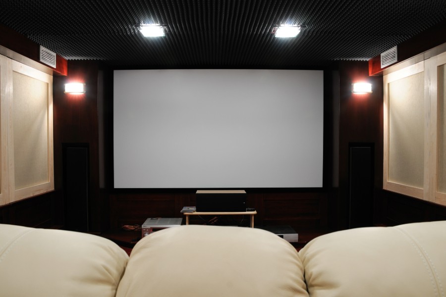  A home theater room showcasing a big screen for enjoying films. 