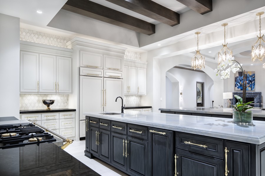 A luxury kitchen in a Martha’s Vineyard home featuring professional lighting design elements. 