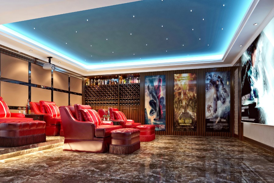 A home theater room with luxurious red leather seats.