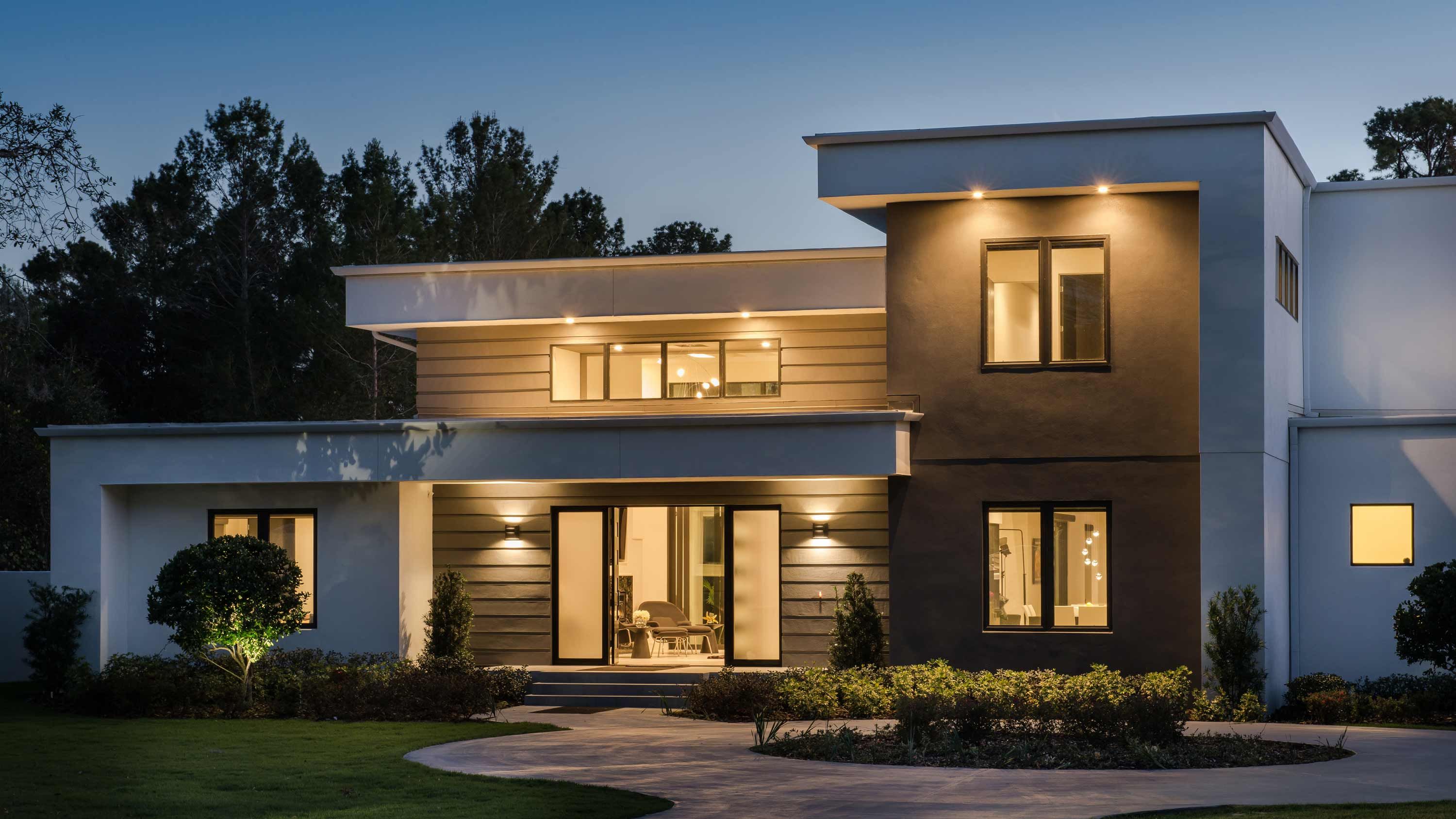 modern home with Lutron lighting at dusk